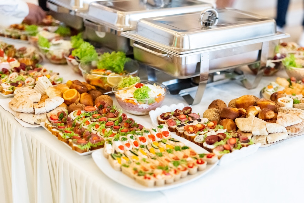 A catered buffet table set with dishes for an event